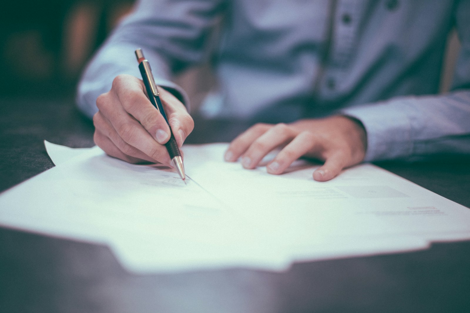 man writing on home insurance policies